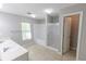 Modern bathroom with double sink vanity, tiled floors, soaking tub, and shower at 1731 Pryor Sw Rd # 109, Atlanta, GA 30315