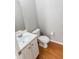 Half bathroom featuring hardwood floors, toilet and single sink vanity at 1731 Pryor Sw Rd # 109, Atlanta, GA 30315