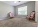 Neutral bedroom featuring natural light from a window, ceiling fan, and two accent chairs at 1731 Pryor Sw Rd # 109, Atlanta, GA 30315