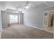 Bright bedroom featuring tray ceilings, ceiling fans, and a view to the bathroom at 1731 Pryor Sw Rd # 109, Atlanta, GA 30315