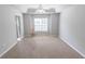 Spacious bedroom with large window, ceiling fan, and neutral carpet at 1731 Pryor Sw Rd # 109, Atlanta, GA 30315