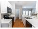 Modern kitchen with white cabinets, stainless steel appliances, and a view into the living area at 1731 Pryor Sw Rd # 109, Atlanta, GA 30315