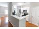 Open kitchen featuring white cabinets, black appliances, a breakfast bar, and views of laundry room at 1731 Pryor Sw Rd # 109, Atlanta, GA 30315