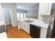 Modern kitchen with white cabinets, stainless steel sink, black appliances, and an open layout at 1731 Pryor Sw Rd # 109, Atlanta, GA 30315