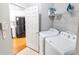 Laundry room featuring white appliances, storage shelf, and a view into the kitchen at 1731 Pryor Sw Rd # 109, Atlanta, GA 30315