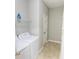 Bright laundry room with tile flooring, white appliances, and ample storage space at 1731 Pryor Sw Rd # 109, Atlanta, GA 30315
