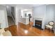 Living room with hardwood flooring, fireplace, stairway and view into the kitchen at 1731 Pryor Sw Rd # 109, Atlanta, GA 30315