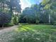 Lush backyard featuring a manicured lawn and mature trees, creating a private oasis at 4735 Cambridge Trce, Atlanta, GA 30338