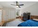 Cozy bedroom with hardwood floors, ceiling fan, and natural light with closet and a desk at 4735 Cambridge Trce, Atlanta, GA 30338