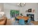 Bright dining area with modern table, fireplace, and sliding doors to outdoor patio space at 4735 Cambridge Trce, Atlanta, GA 30338