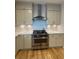 Well-lit kitchen with neutral cabinets, stainless steel range, and light hardwood flooring at 4735 Cambridge Trce, Atlanta, GA 30338