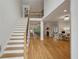 Bright living room with staircase, wood floors, two-story ceiling, and a view to dining area at 4735 Cambridge Trce, Atlanta, GA 30338