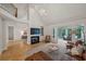 Inviting living room with a fireplace, high ceilings, and seamless flow to sunroom and dining area at 4735 Cambridge Trce, Atlanta, GA 30338