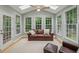 Cozy sunroom filled with natural light featuring skylights, multiple windows, and comfortable seating at 4735 Cambridge Trce, Atlanta, GA 30338
