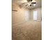 Spacious carpeted bedroom with ceiling fan and multiple entry doors at 4831 Oak Path, Stone Mountain, GA 30088