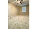 Carpeted bedroom with a ceiling fan and a bright window bringing in natural light at 4831 Oak Path, Stone Mountain, GA 30088
