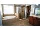 Bright bathroom with a soaking tub, glass shower, and tile flooring at 760 King Sword Ct, Mableton, GA 30126