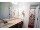 Bright bathroom with a spacious vanity and framed mirror, complemented by a floral shower curtain at 760 King Sword Ct, Mableton, GA 30126
