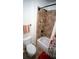 Cozy bathroom featuring a tiled corner shower and tub with a neutral color scheme and red accent rug at 760 King Sword Ct, Mableton, GA 30126