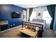 Bedroom with a study desk, mounted television, and a cozy atmosphere at 760 King Sword Ct, Mableton, GA 30126