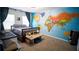 Bedroom decorated with a colorful world map mural, complemented by a bed, desk, and natural light at 760 King Sword Ct, Mableton, GA 30126