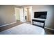 Bedroom with plush carpet, neutral walls, TV on a console and a view into the en suite bathroom at 760 King Sword Ct, Mableton, GA 30126