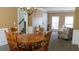 Dining room with wainscoting, wood table, and a chandelier, with views to foyer and living room at 760 King Sword Ct, Mableton, GA 30126