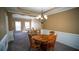 Dining room with tan walls, white trim, wood table, and a chandelier, bathed in natural light at 760 King Sword Ct, Mableton, GA 30126