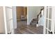 Foyer featuring wood floors, gray carpeted stairs, and view to a sitting room, bathed in natural light at 760 King Sword Ct, Mableton, GA 30126