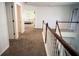 Hallway with carpeted floors, white railings and doors offering seamless transitions between spaces at 760 King Sword Ct, Mableton, GA 30126