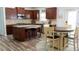 Spacious kitchen with dark wood cabinets, granite countertops, stainless steel appliances, and wood floors at 760 King Sword Ct, Mableton, GA 30126