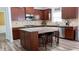 Spacious kitchen with dark wood cabinets, granite countertops, stainless steel appliances, and a center island at 760 King Sword Ct, Mableton, GA 30126