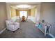Inviting living room with wainscoting, carpet, tray ceiling, stylish furniture, and large windows at 760 King Sword Ct, Mableton, GA 30126