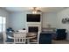 Cozy living room with a fireplace, ceiling fan, mounted television, and comfortable furnishings at 760 King Sword Ct, Mableton, GA 30126