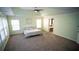 Airy main bedroom featuring a tray ceiling, neutral carpet, and an abundance of natural light at 760 King Sword Ct, Mableton, GA 30126