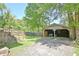 View of the backyard featuring an outbuilding, complemented by lush greenery and a stairway in the background at 78 Atlanta Se Ave, Atlanta, GA 30315