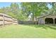 Expansive backyard with mature trees, a fenced perimeter, and an outbuilding, offering privacy and storage at 78 Atlanta Se Ave, Atlanta, GA 30315