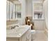 Traditional bathroom with white fixtures, tile floors, and a window for natural light at 78 Atlanta Se Ave, Atlanta, GA 30315