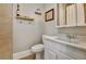Bathroom with a toilet, vanity with mirror, light, and floating shelves with decorations at 78 Atlanta Se Ave, Atlanta, GA 30315