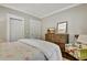 Bedroom featuring a floral chair, a TV, a wooden dresser, and two closets at 78 Atlanta Se Ave, Atlanta, GA 30315