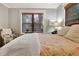 Bright bedroom with natural-fiber window shades, a comfortable chair, and soft neutral colors at 78 Atlanta Se Ave, Atlanta, GA 30315