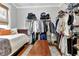 Bedroom converted to closet with the bed pushed against the wall and clothing racks at 78 Atlanta Se Ave, Atlanta, GA 30315