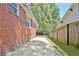 Brick exterior of a home, showcasing a spacious driveway and gated access to the backyard at 78 Atlanta Se Ave, Atlanta, GA 30315