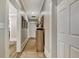 Long hallway with light gray walls, white trim, and a wood cabinet decorated with flowers at 78 Atlanta Se Ave, Atlanta, GA 30315
