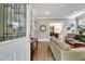 Inviting living room with hardwood floors, a decorative mirror, and a view into the dining area at 78 Atlanta Se Ave, Atlanta, GA 30315