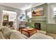Comfortable living room featuring a fireplace, TV, patterned chair, and view into the dining room at 78 Atlanta Se Ave, Atlanta, GA 30315