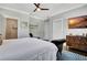 A beautifully furnished bedroom with a decorative ceiling fan, a TV, and a modern-styled chair at 78 Atlanta Se Ave, Atlanta, GA 30315