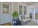 Charming front porch entrance featuring a glass-paneled door, stylish seating, and green plants at 78 Atlanta Se Ave, Atlanta, GA 30315