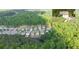 Aerial view of suburban homes surrounded by lush trees and a small lake at 149 Manor Ln, Woodstock, GA 30188
