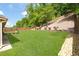 Spacious backyard with a well-maintained lawn, privacy fence, and professional landscaping at 149 Manor Ln, Woodstock, GA 30188